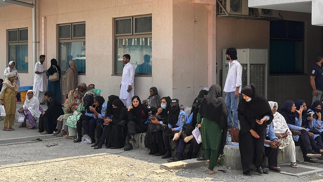 Relatives of the hospital fire victims gather outside the mortuary