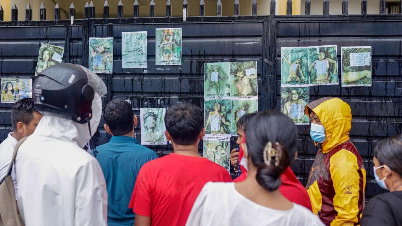 People look at photographs of missing people in Kathmandu, Nepal