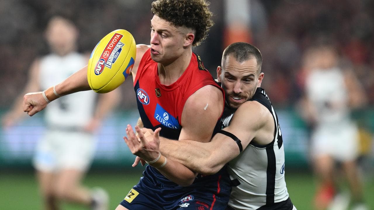 Francis Evans of Carlton tackles Koltyn Tholstrup of the Demons.