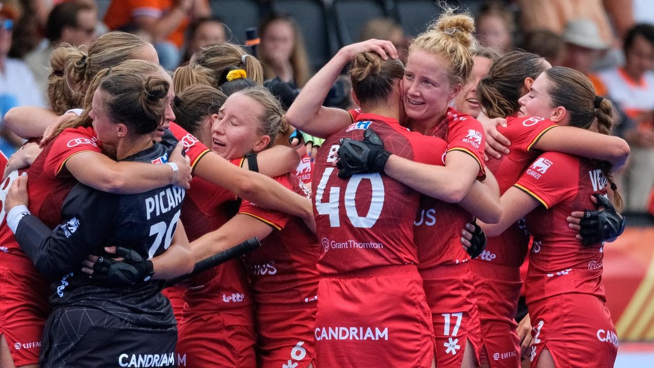 Belgium players celebrate beating Hockeyroos.
