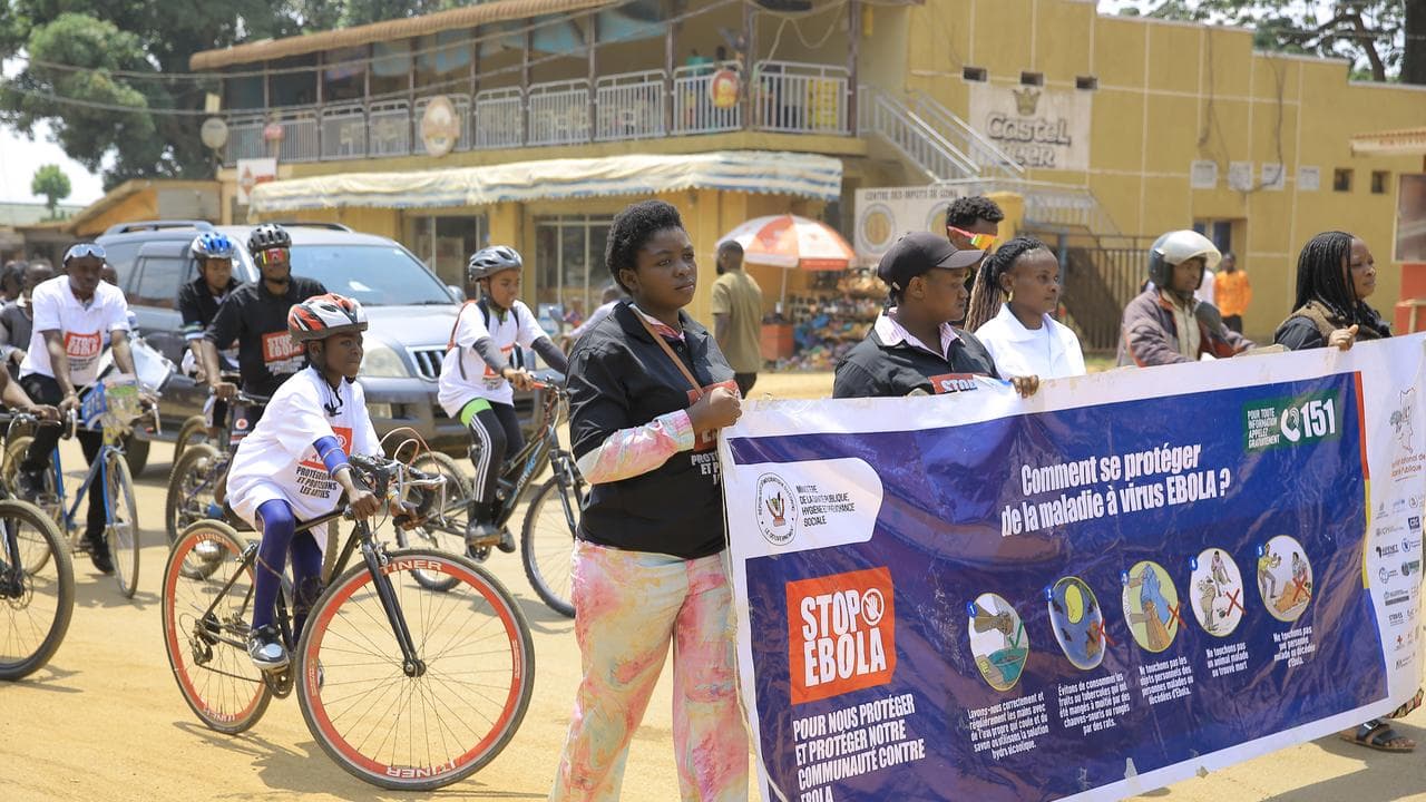 Residents take part in an Ebola outbreak awareness campaign