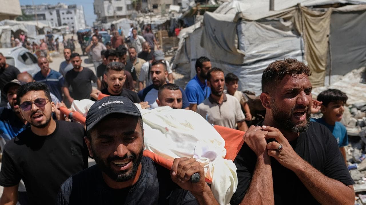 Palestinians carry the body of Abdullah Hamouda, 14,