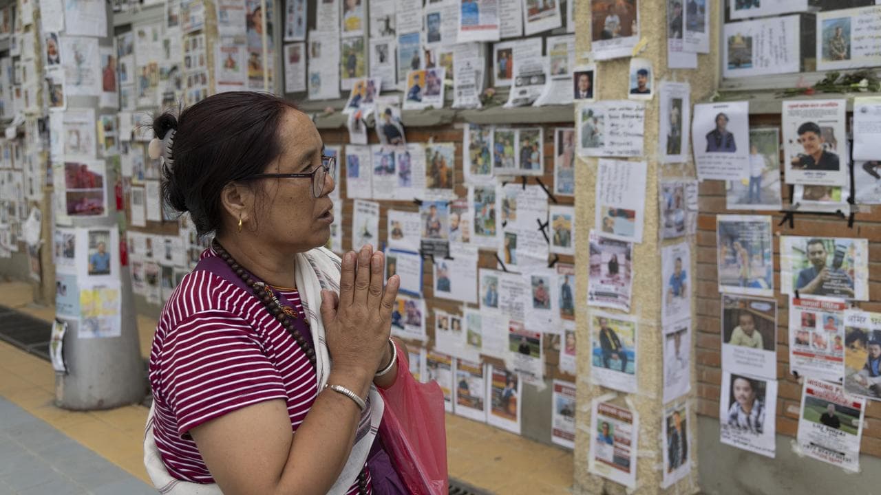 Bereaved families perform funeral
