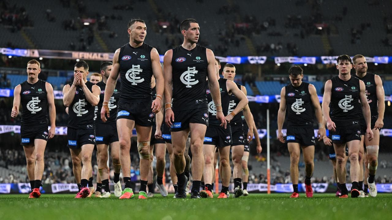 Carlton players leave the field