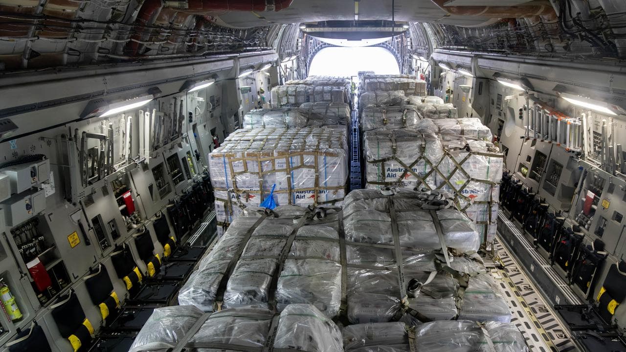 Pallets of aid on a plane.