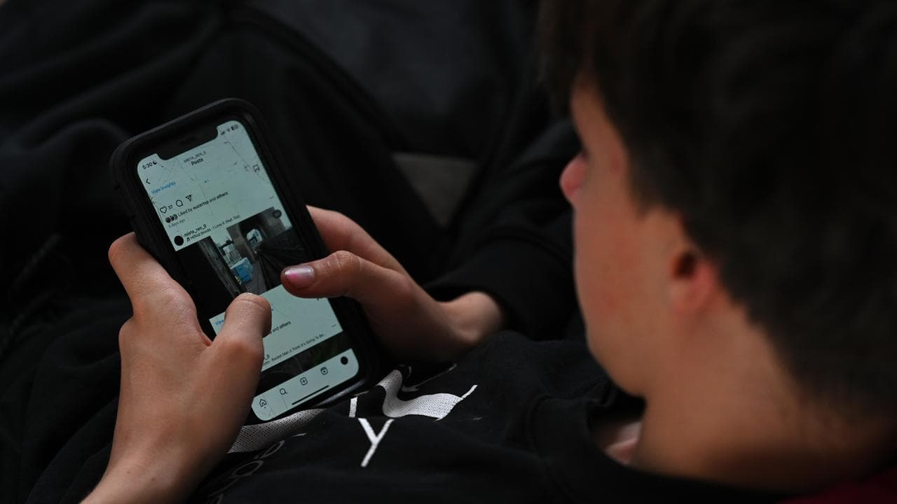 A teenager uses a mobile phone