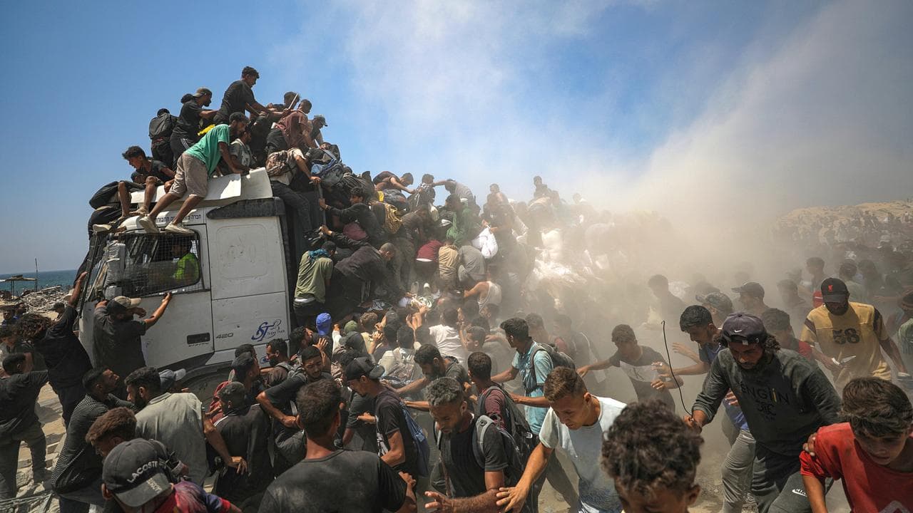 Palestinians at a food aid truck in northern Gaza, July 27, 2025.