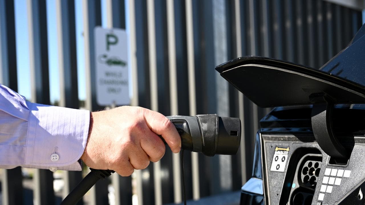 A person charging an EV