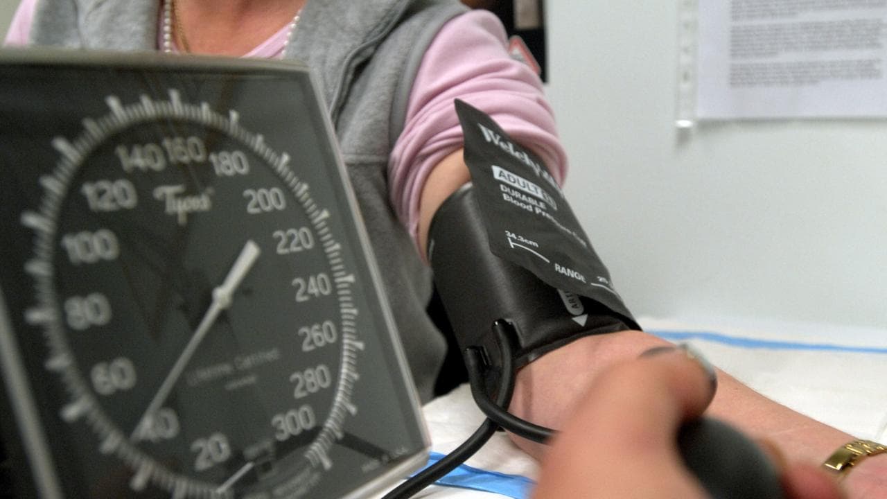A patient has her blood pressure checked