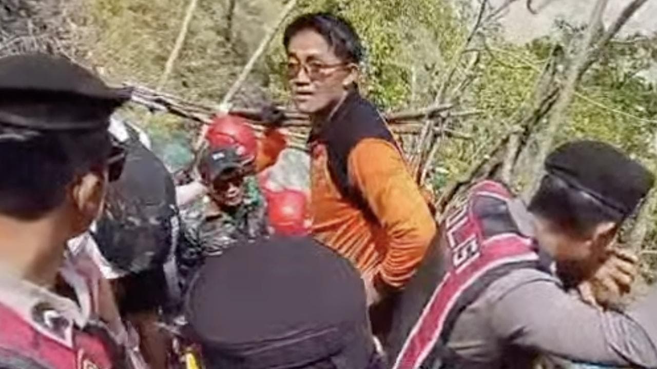 Rescue teams retrieve the woman's body