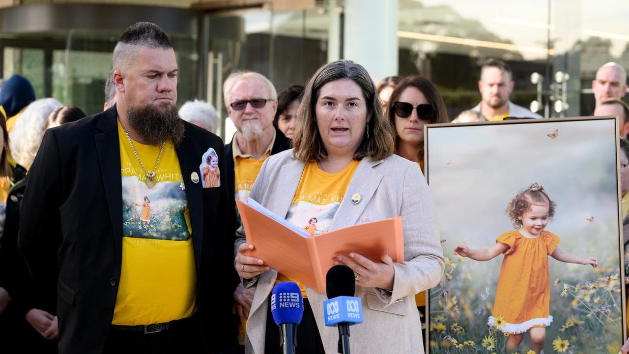 Annah White speaks next to photo of daughter