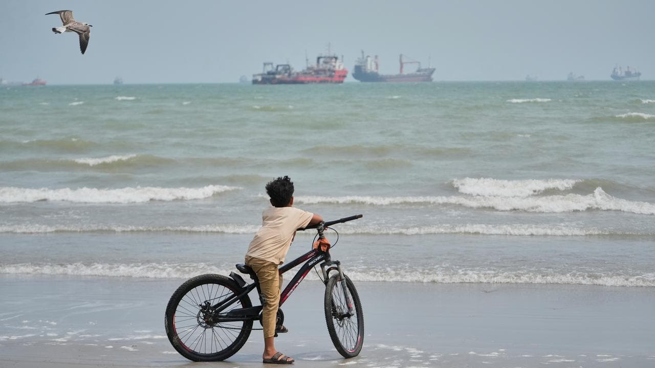 A beach in Iran overlooking vessels anchored in the Strait of Hormuz