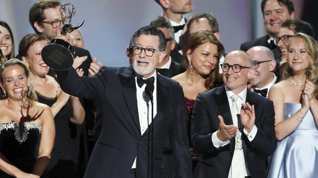 Stephen Colbert (C), with cast and crew