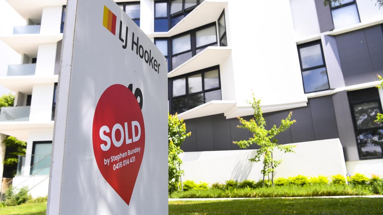 A sold sign is seen outside an apartment block in Canberra