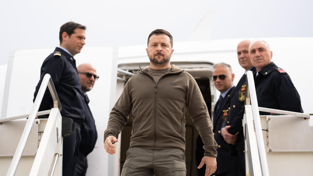 Ukrainian President Volodymyr Zelenskiy disembarks from a plane