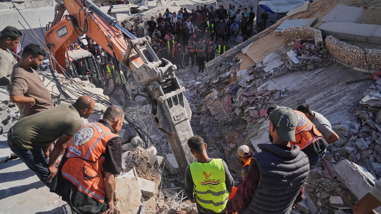 Crews search for bodies in the rubble of a collapsed building in Gaza