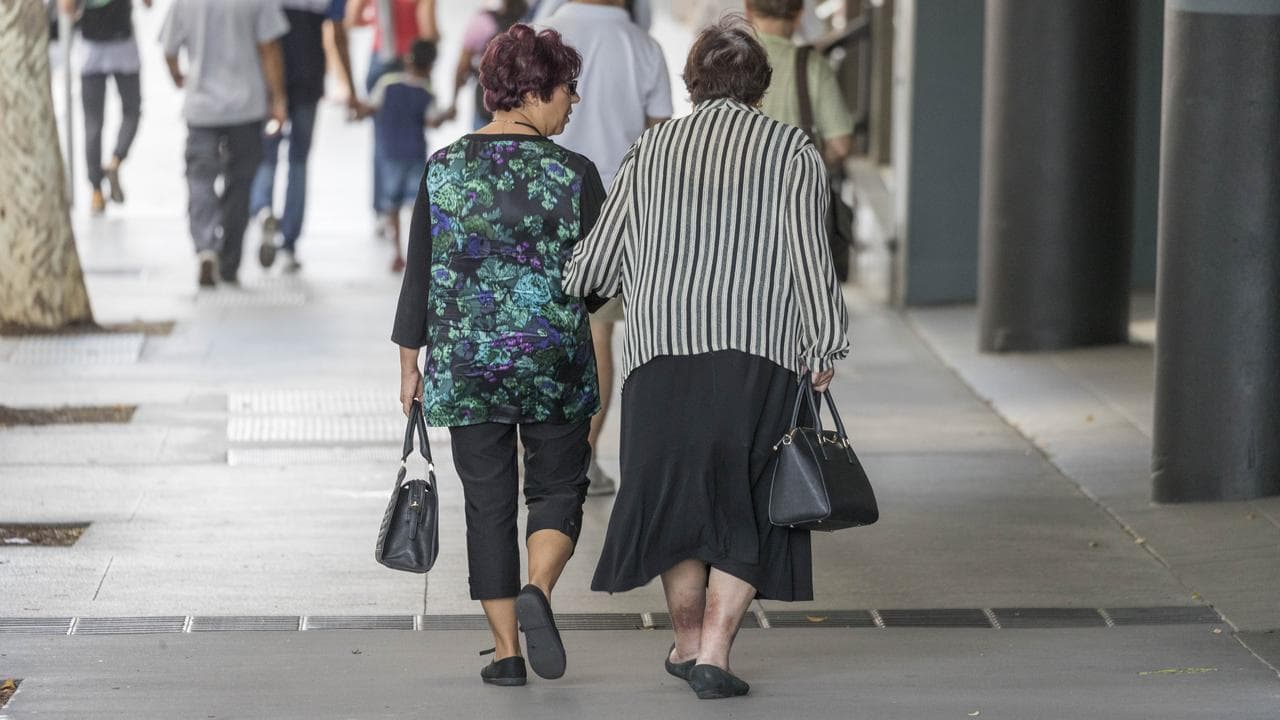 Elderly people walk in the street
