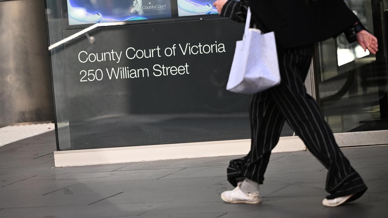 Person walking past court