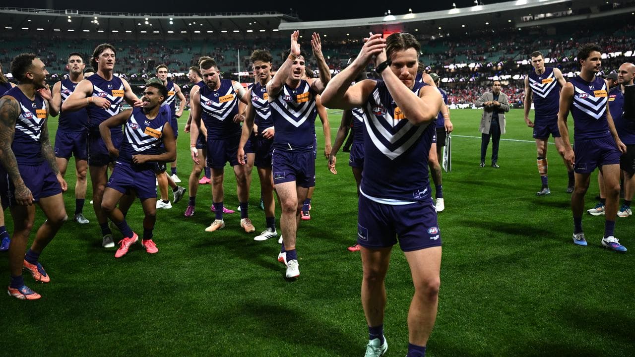 Fremantle players applaud their fans.