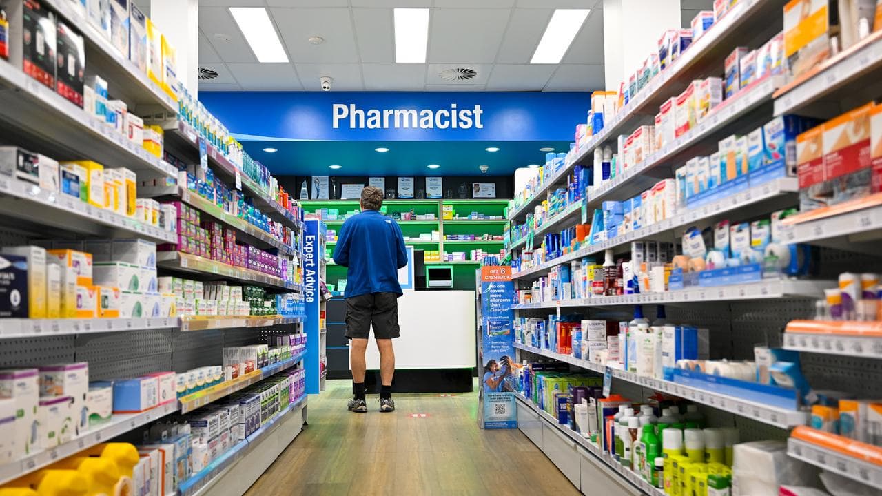 A customer waits at a counter of a pharmacy