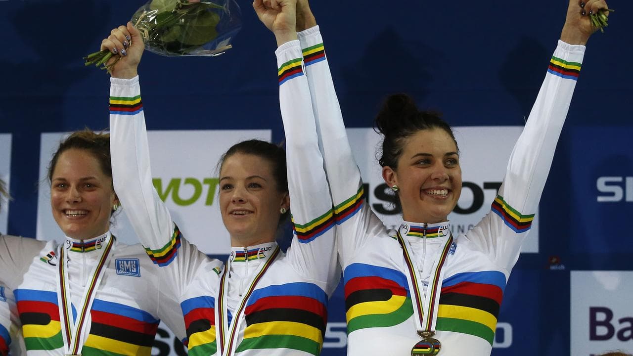 women in rainbow jerseys on podium