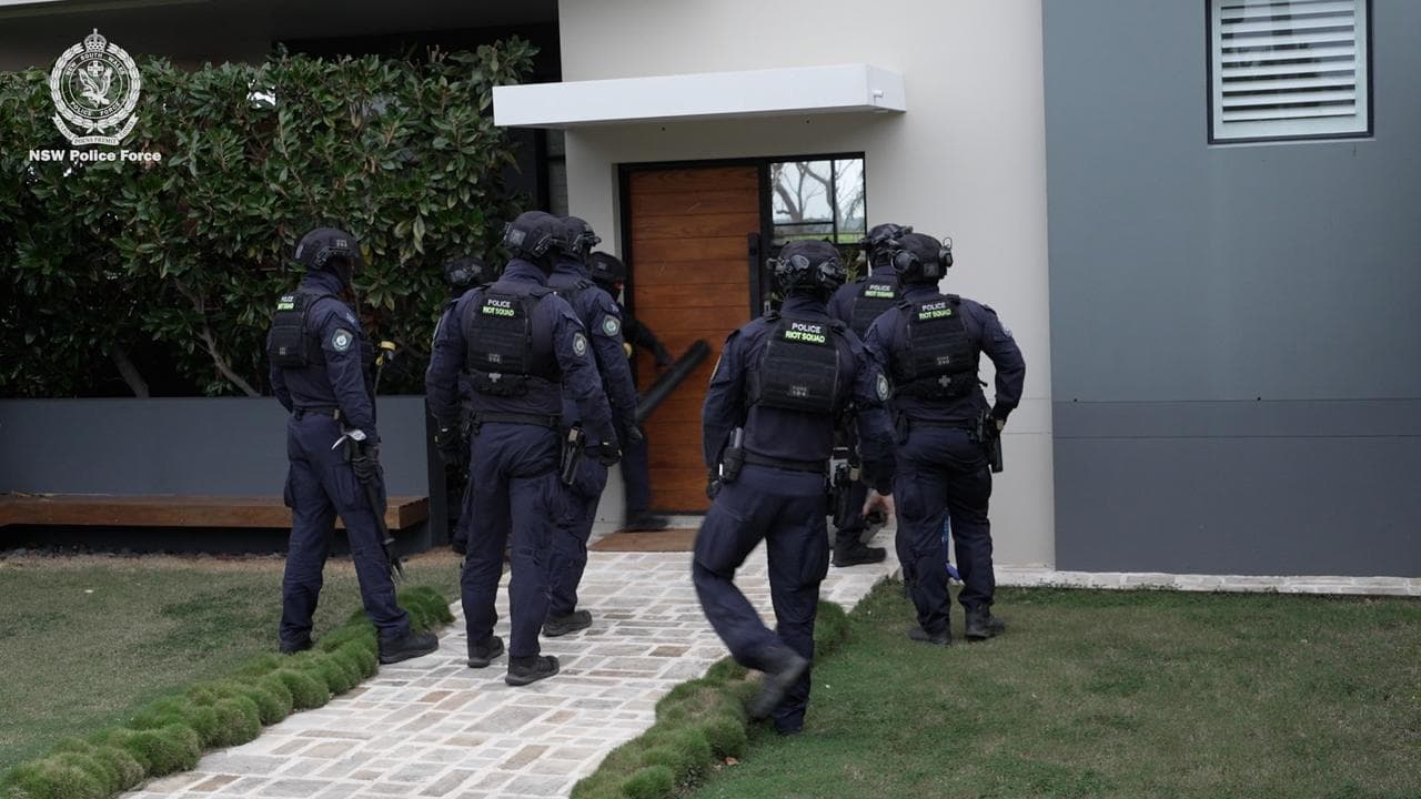 Riot police raiding a home in Sydney.