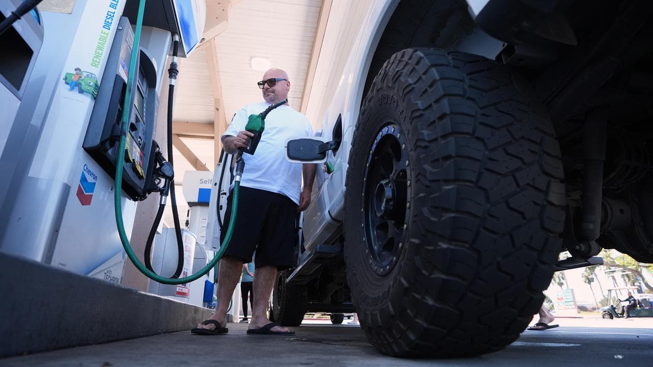 A man puts $US175 dollars of diesel in his truck in California