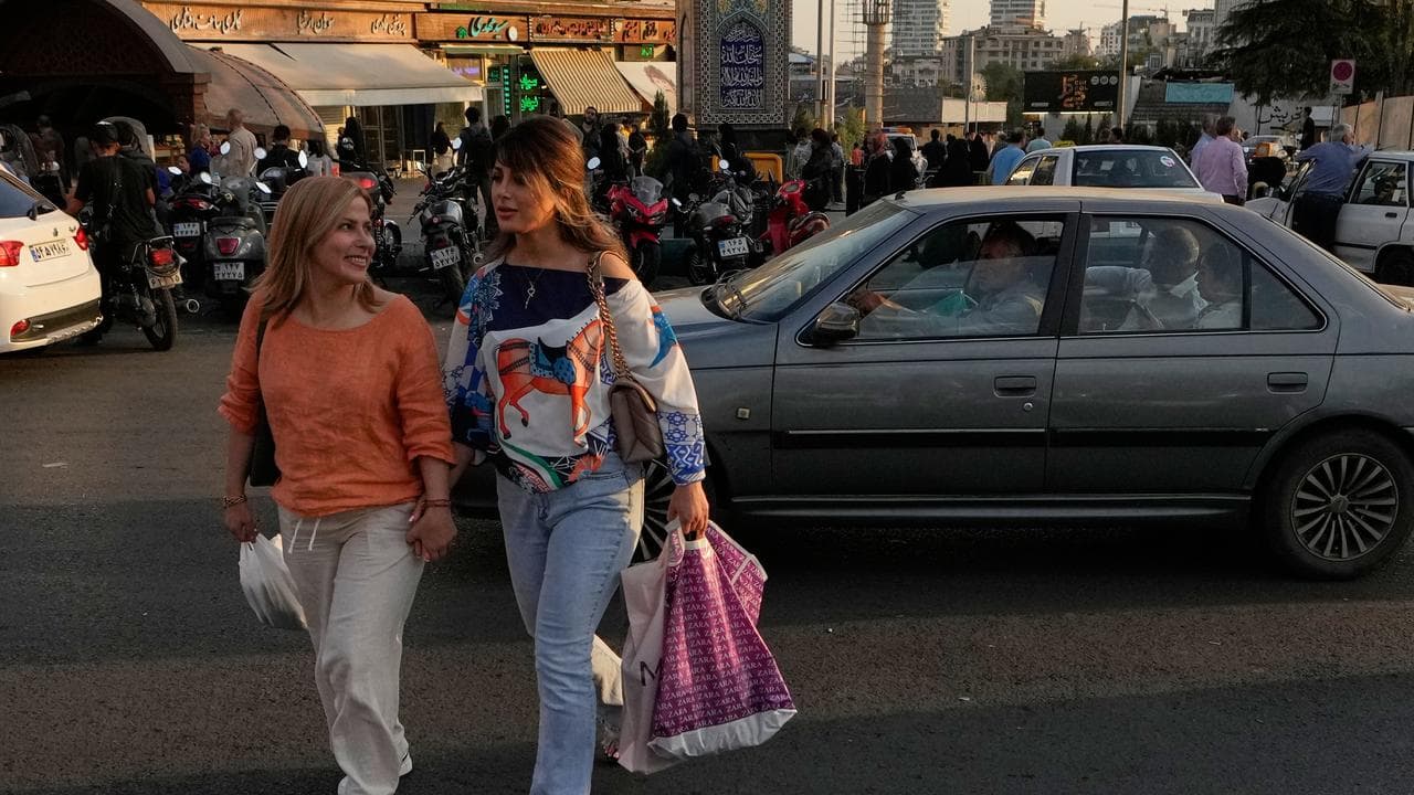 Women carry their shopping bags in northern Tehran