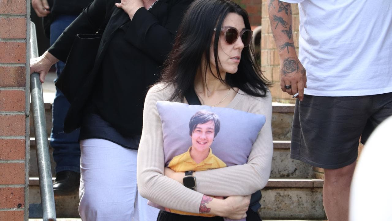 woman leaving court with pillow