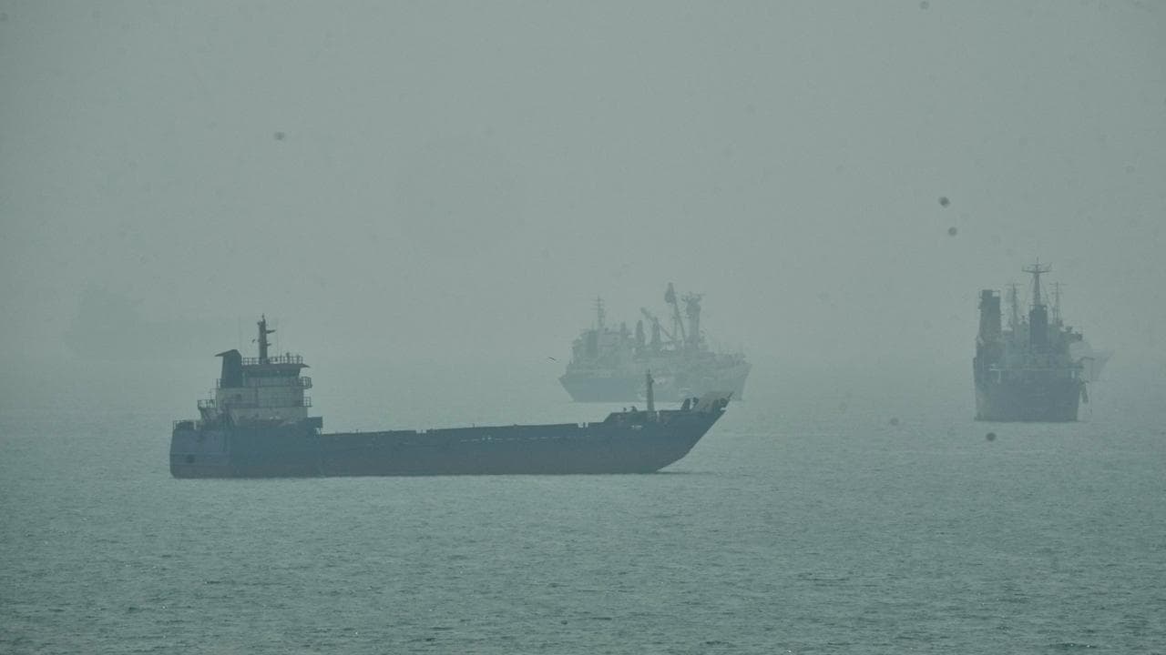 Commercial vessels anchored amid haze in the Strait of Hormuz