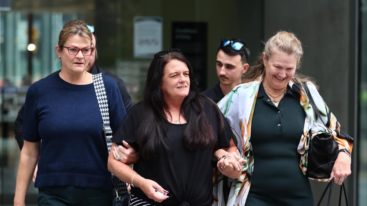 Kylie arm in arm with friends
