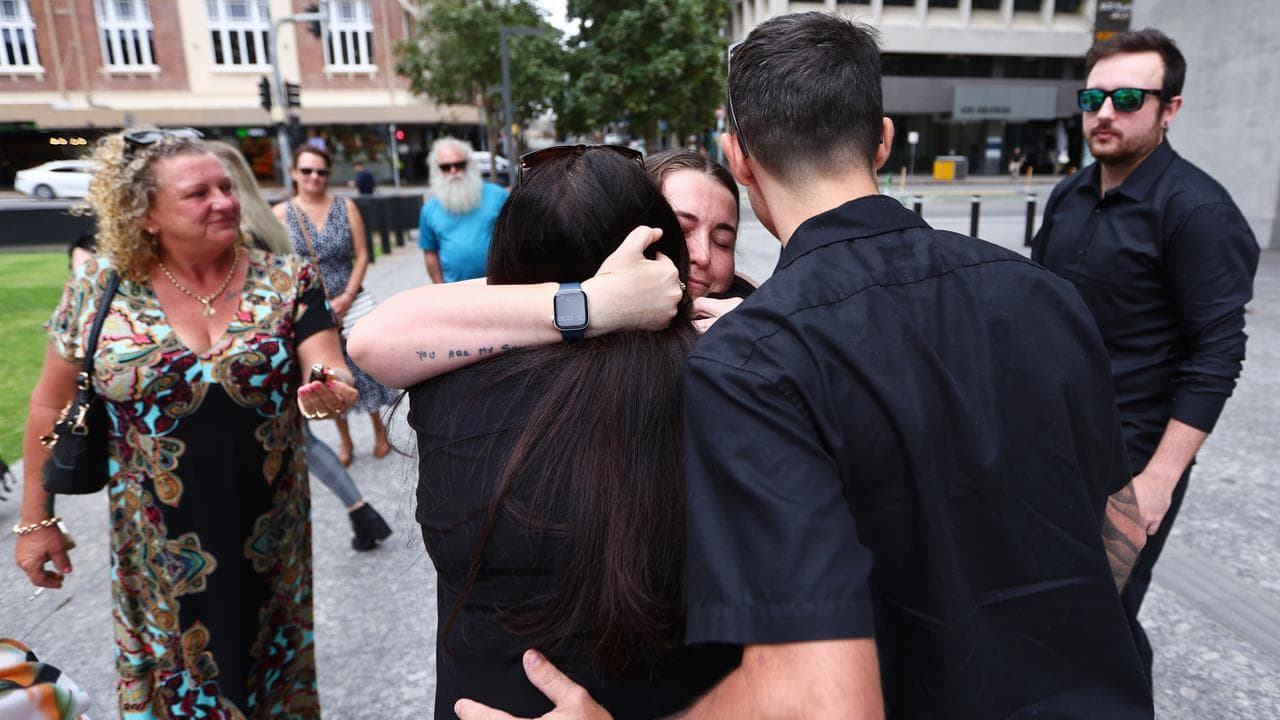 woman hugged by man and woman