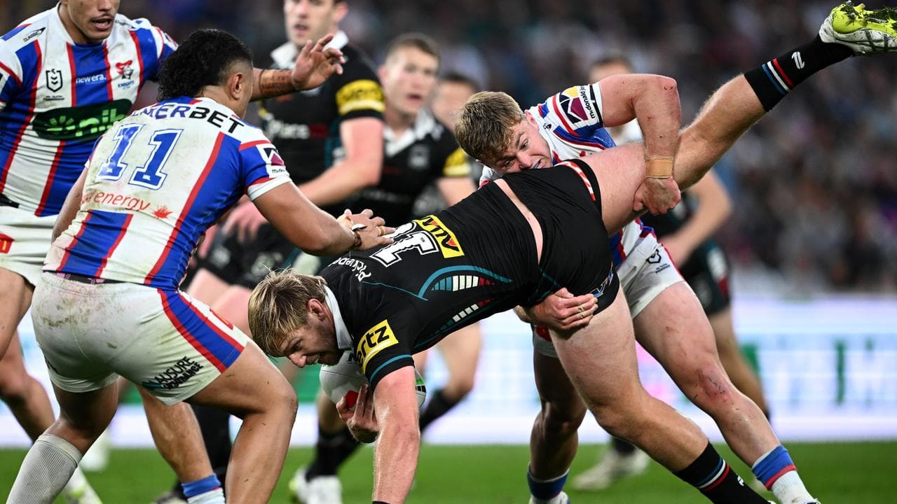 Newcastle's Harrison Graham tackles the Panthers' Lindsay Smith