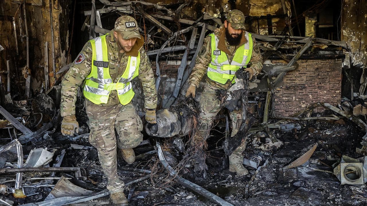 Experts recover a drone engine after a Russian strike in Kyiv