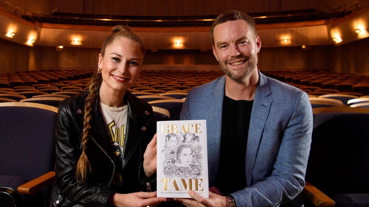man and woman holding book
