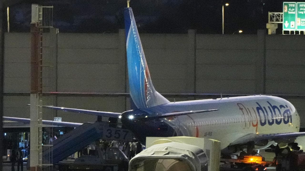 People disembark from a jet after experiencing an emergency landing