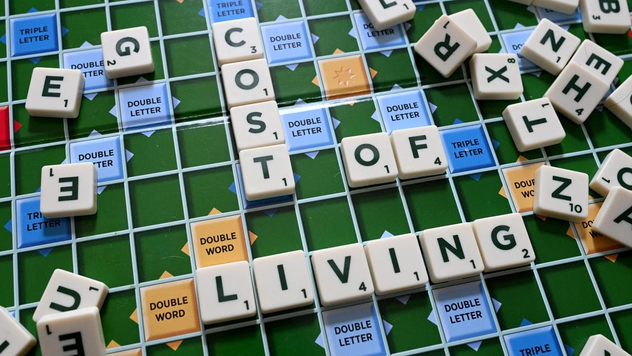 words ‘Cost of Living’ are seen on a scrabble board