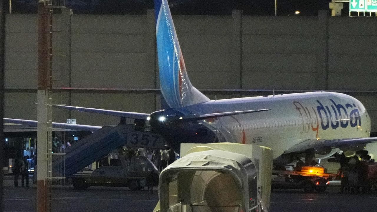 Passengers disembark a FlyDubai plane after their ordeal