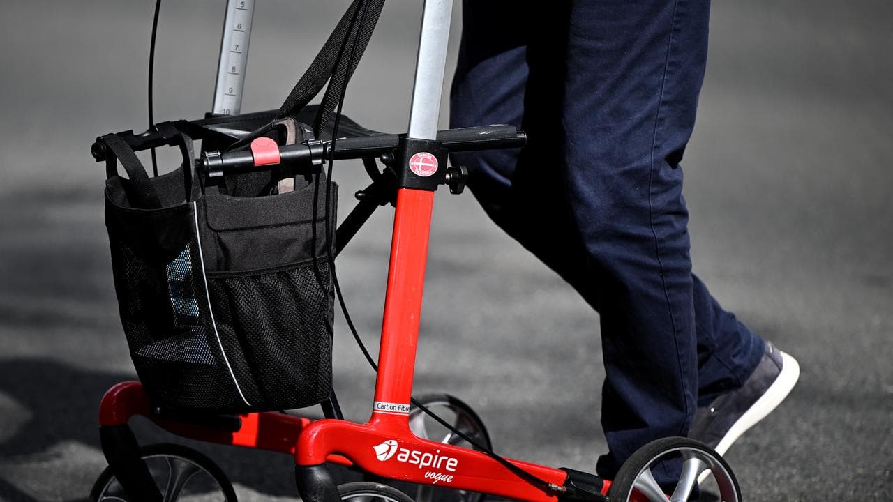 A member of the public is seen using a walker