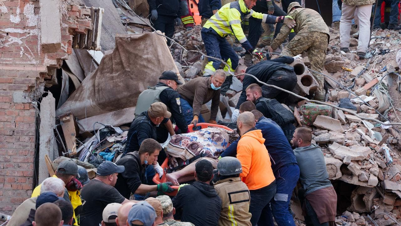 Rescuers carry bodies after a Russian missile strike in Pryluky
