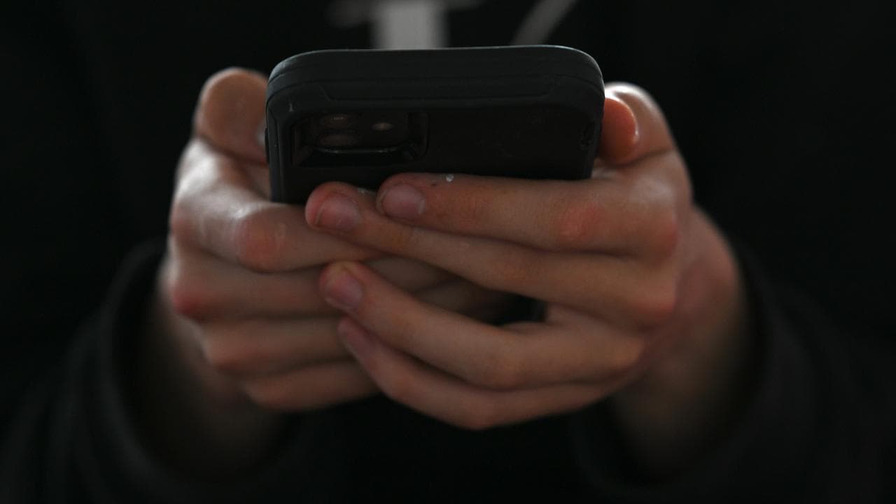 A teenager uses his mobile phone (file image)