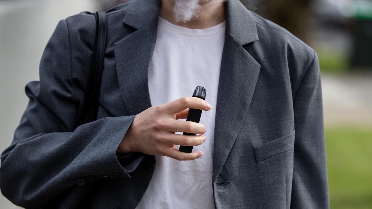 A stock image of a person vaping.