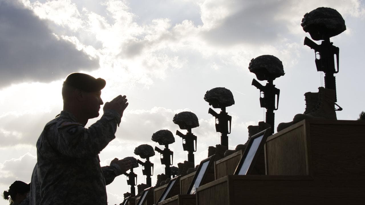Soldiers salute as they honour victims of the Fort Hood shooting