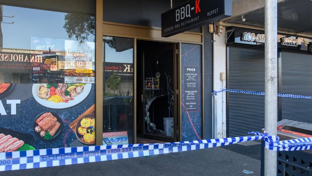 A fire-damaged entrance is seen at a Korean barbecue restaurant