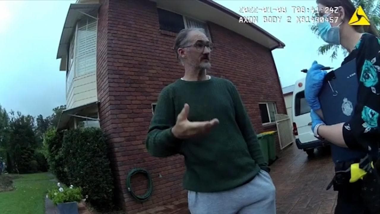 man speaking to police outside home