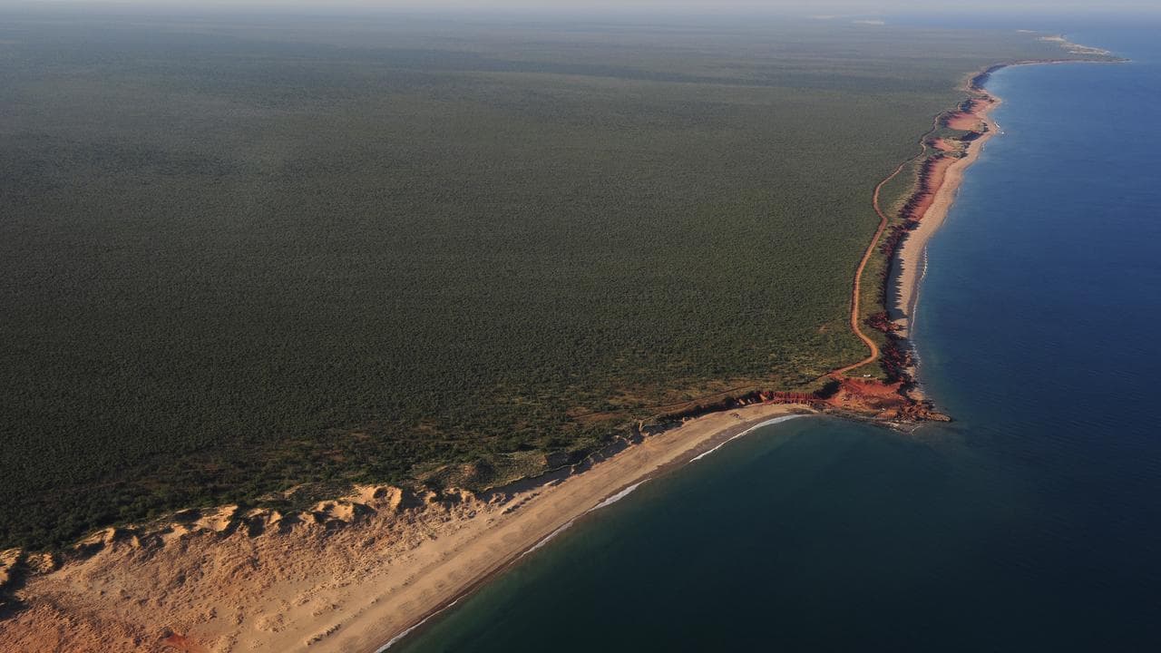 airplane shot of remote tropical coastline with little human activity