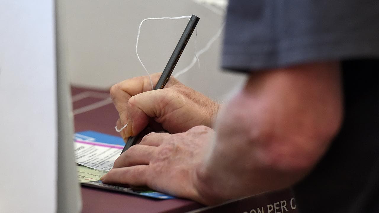 A voter makes his selection at a polling booth