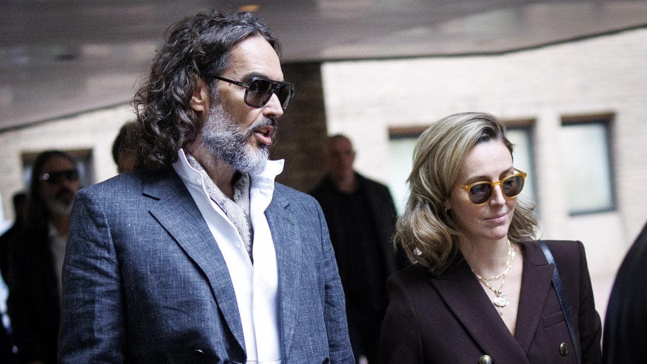 Russell Brand and wife Laura Gallacher outside London court