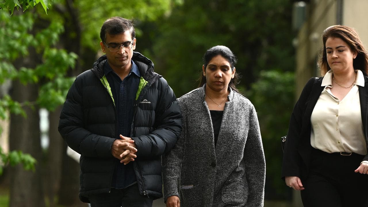 three people walk along a footpath