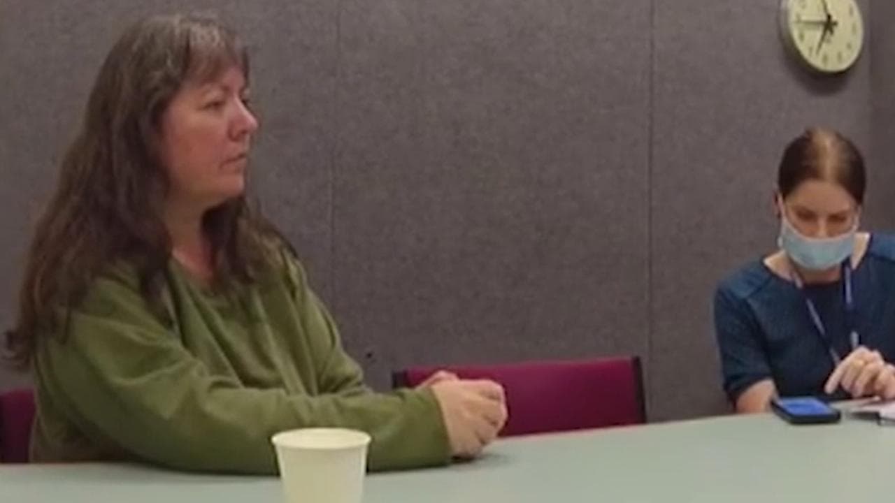 woman speaks with police